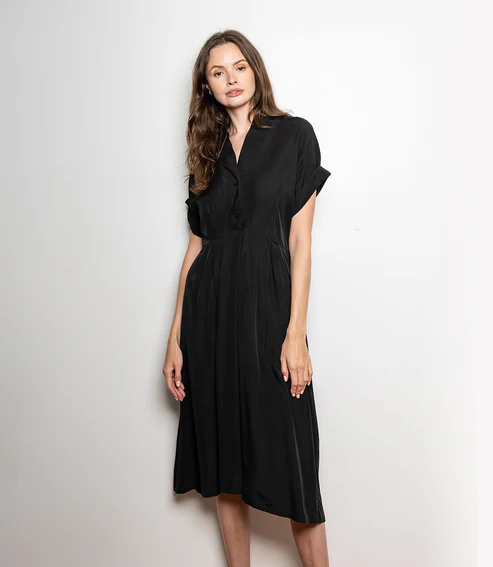 A woman wearing a classic black dress styled simply and elegantly